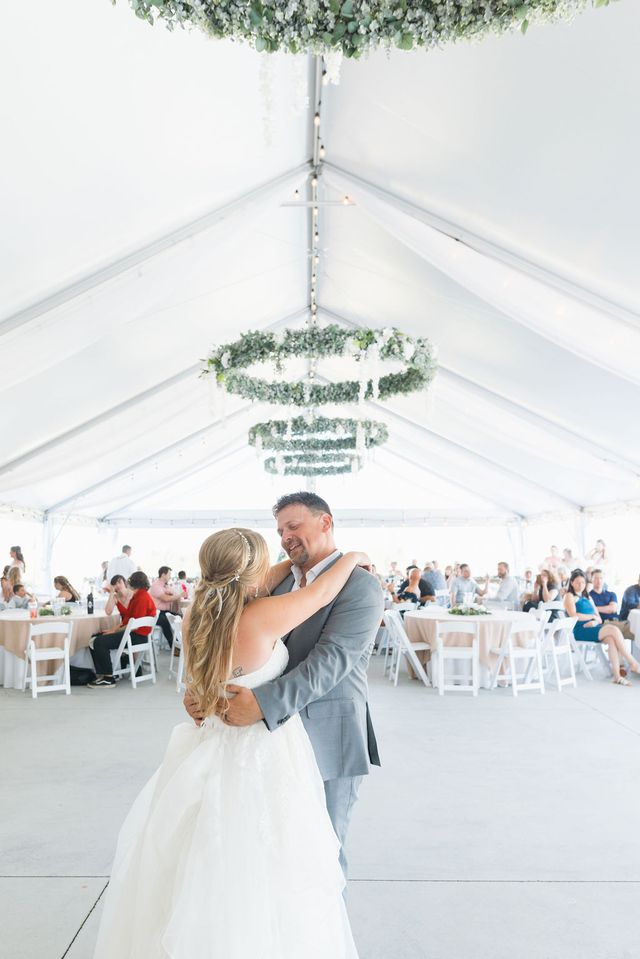 Father and daughter dance at a garden wedding venue