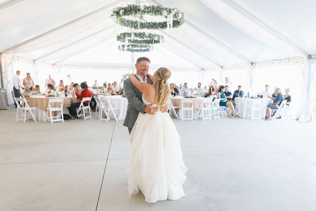 Father and daughter wedding dance at a garden party wedding with mountain backdrop at a Coeur D'alene wedding venue