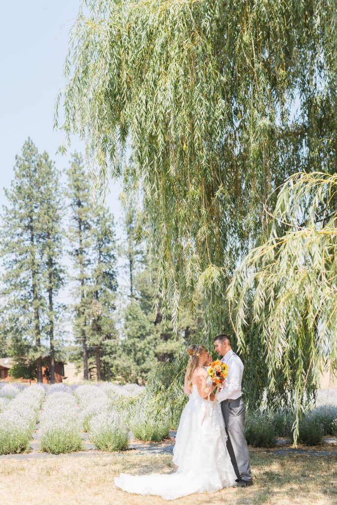 Bride and groom embrace at a garden wedding venue near Spokane