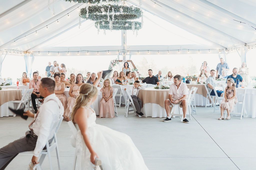 Bride and groom playing the Shoe Game with Wedding Guests at their Spokane Washington wedding reception