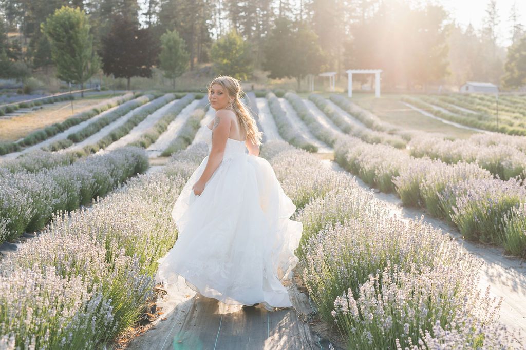 Bride wearing a luxury wedding dress poses for wedding day photos in a garden wedding venue near Spokane