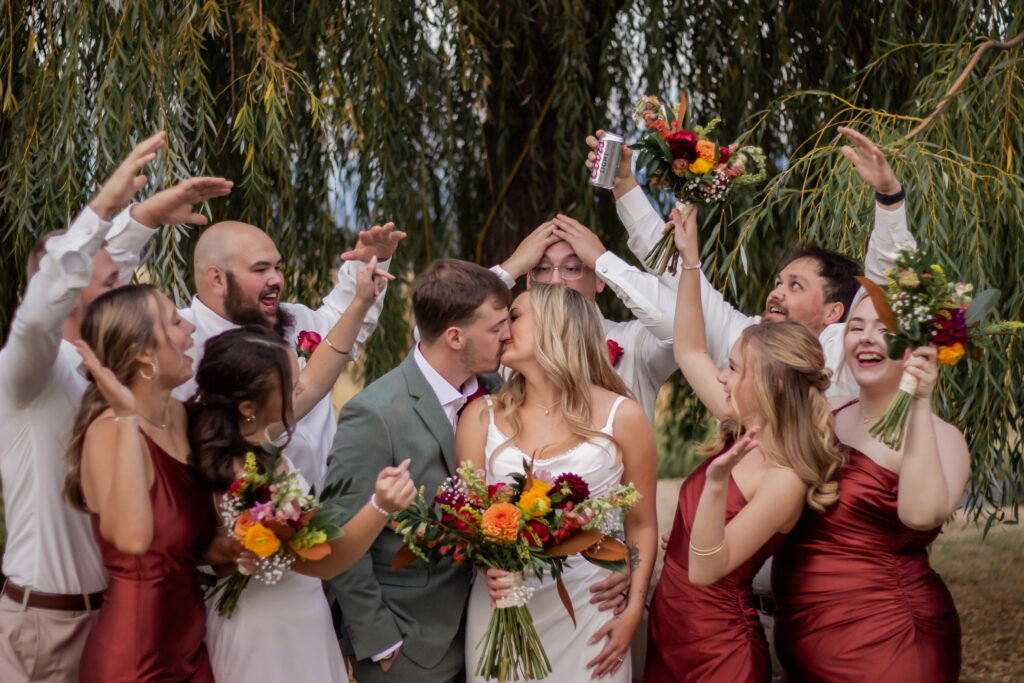 Bridesmaids and groomsmen pose for wedding day photography at a garden wedding venue near Spokane
