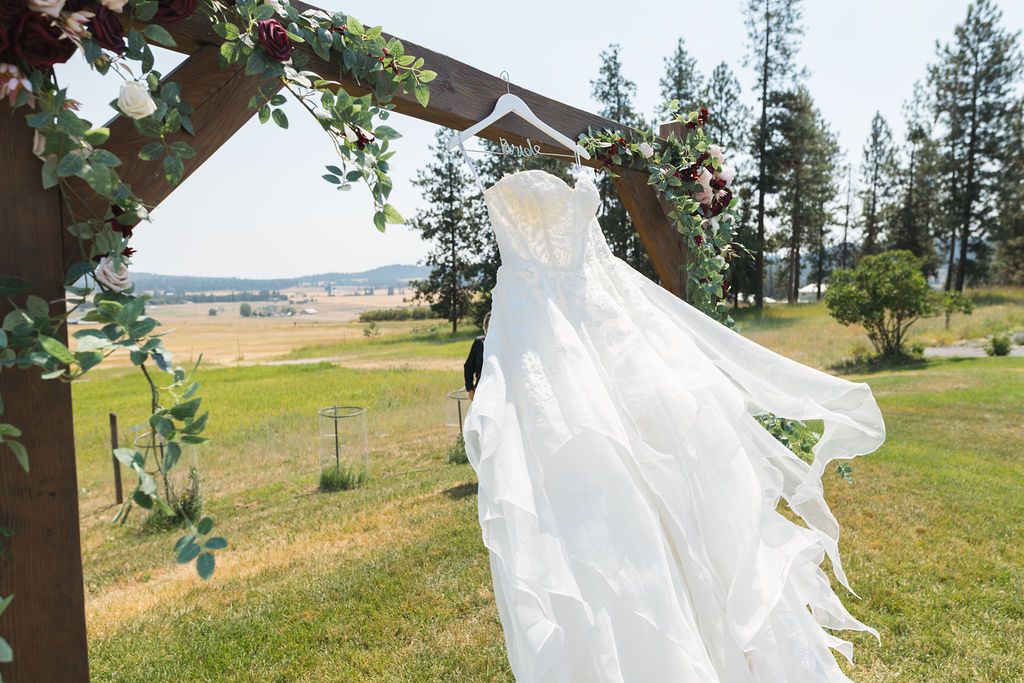 Wedding dress blowing in the wind at Lavender Manor wedding venue with acres of lavender fields & mountain views in the backdrop