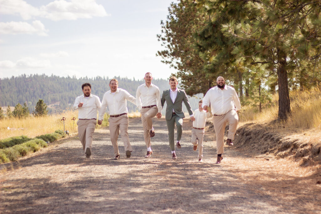 Fall Wedding Venue Near Spokane With Mountain Views 4 Groom, groomsmen and ring bearer have fun during their fall wedding photo session with mountain views in the backdrop!